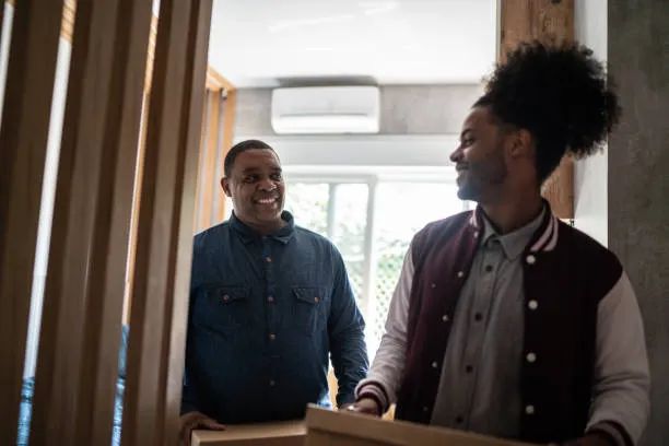 A staff member welcoming a new resident at the door